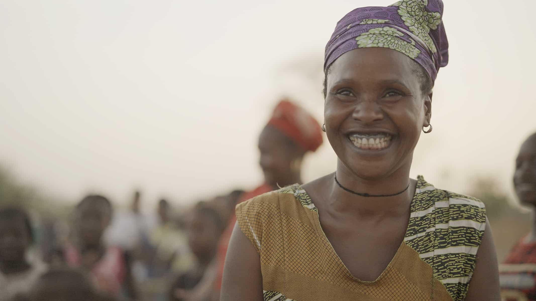 Smiling woman celebrates 32 years of Trees for the Future's agroforestry education.