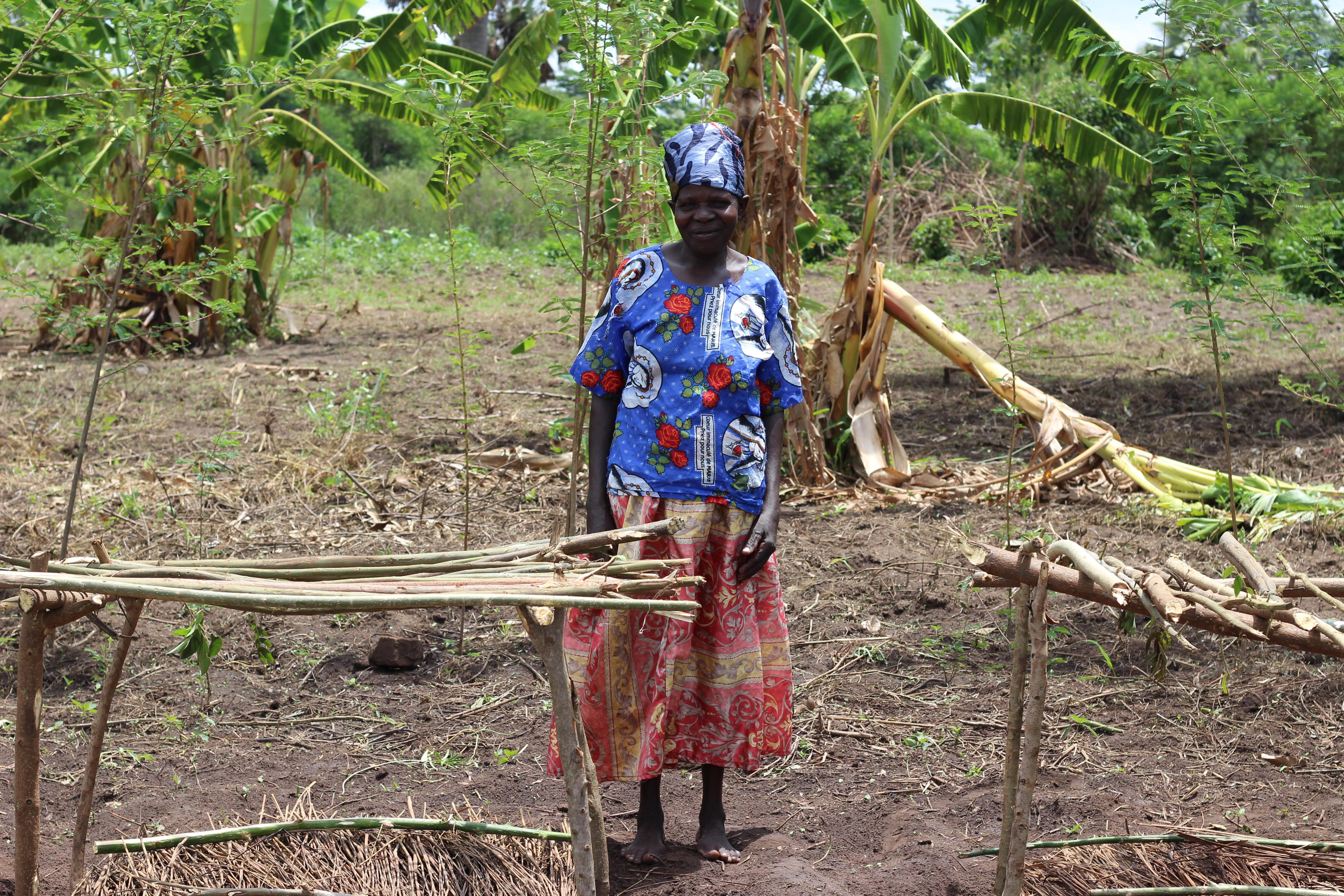 Ajok standing in her farm