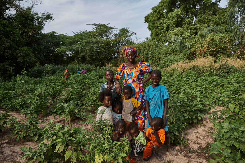 A woman standing with her kids.